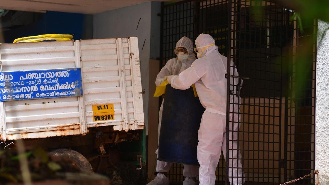 Health workers in PPE kits removing waste from the premises of the Nipah isolation ward at Government Medical College Hospital, Kozhikode