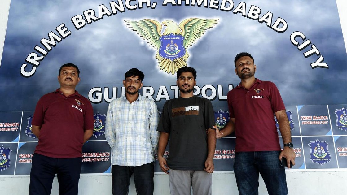 Ahmedabad police presenting arrested suspects Sumer Singh and Akash Meena in NEET re-exam scam