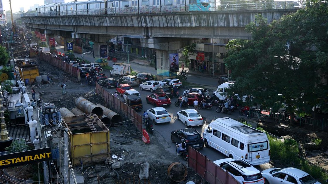 Kochi city traffic jam at a busy intersection with vehicles and auto-rickshaws