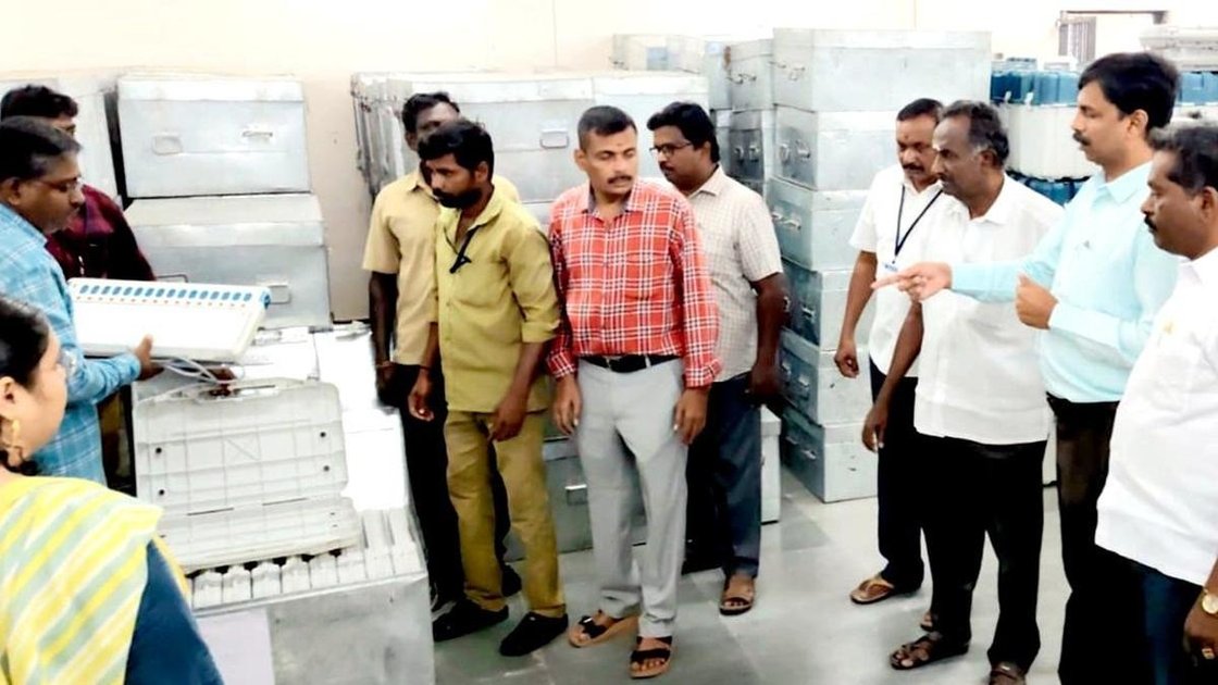 Erode District Election Officer and Collector S. Kandasamy inspecting EVMs during first-level checking at the warehouse in Perundurai on June 16, 2026.