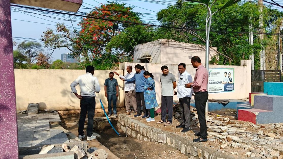 Cyberabad Municipal Corporation workers cleaning stormwater drain at a waterlogged location