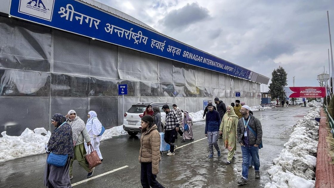 Travellers walk inside Srinagar International Airport amid snow piled up after heavy snowfall, in Srinagar, on February 3, 2026.