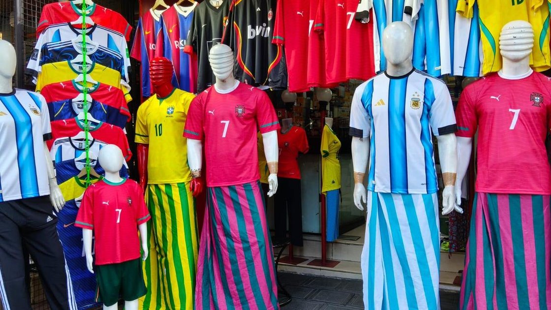 Mannequins wearing football-themed mundus and lungis outside a store in Kerala