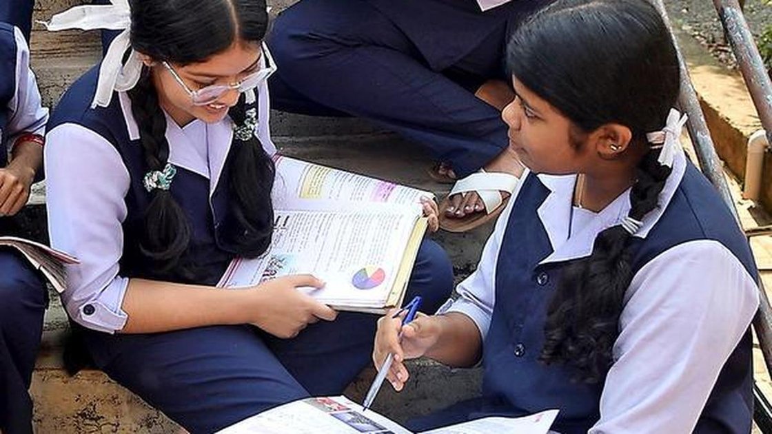 Representational image of students checking Plus One allotment list on a computer screen
